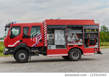 In this captivating scene, a state-of-the-art firetruck, equipped with advanced rescue technology, stands ready with its skilled firefighting team, prepared to intervene and respond rapidly to In this captivating scene, a state-of-the-art firetruck, equipped with advanced rescue technology, stands ready with its skilled firefighting team, prepared to intervene and respond rapidly to 123522443