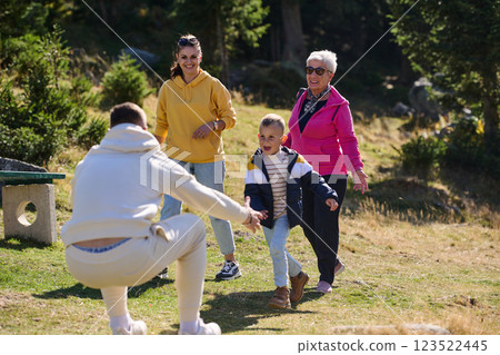 A family shares delightful moments with their friends amid the stunning landscapes of mountains, lakes, and winding paths, promoting a healthy lifestyle and the joy of familial bonds in the embrace of A family shares delightful moments with their friends amid the stunning landscapes of mountains, lakes, and winding paths, promoting a healthy lifestyle and the joy of familial bonds in the embrace of 123522445