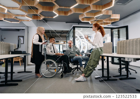 Young group of business people brainstorming together in a startup space, discussing business projects, investments, and solving challenges 123522533