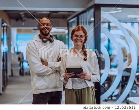 In a modern office African American young businessman and his businesswoman colleague, with her striking orange hair, engage in collaborative problem-solving sessions In a modern office African American young businessman and his businesswoman colleague, with her striking orange hair, engage in collaborative problem-solving sessions 123522611