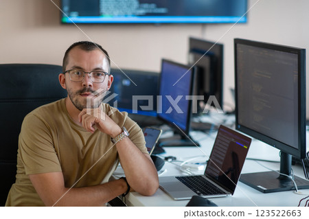 A programmer diligently testing smartphone applications while sitting in their office. 123522663