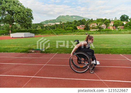 A woman with disablity driving a wheelchair on a track while preparing for the Paralympic Games A woman with disablity driving a wheelchair on a track while preparing for the Paralympic Games 123522667