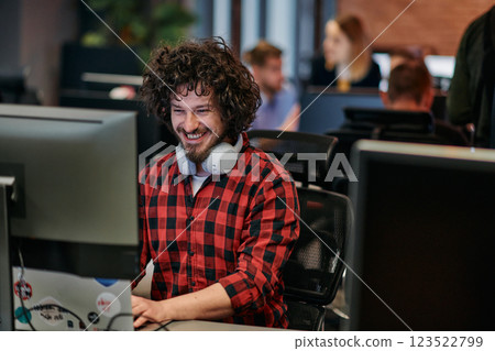 Focused Programmer With Afro Hairstyle in Plaid Shirt Working on Computer in Office Environment Focused Programmer With Afro Hairstyle in Plaid Shirt Working on Computer in Office Environment 123522799
