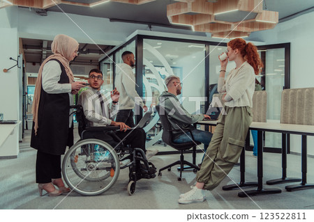Young group of business people brainstorming together in a startup space, discussing business projects, investments, and solving challenges. Young group of business people brainstorming together in a startup space, discussing business projects, investments, and solving challenges. 123522811