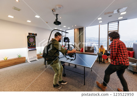 Videographer Captures Business Colleagues Playing Table Tennis During Break 123522950