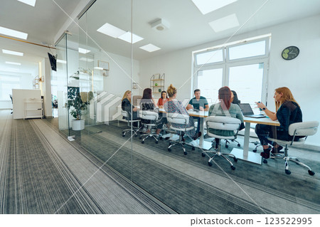 Diverse Business Team Discussing Projects in a Modern Glass Office. 123522995