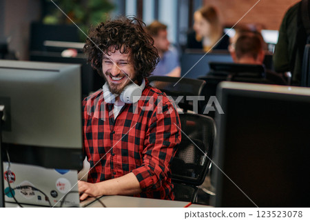 Focused Programmer With Afro Hairstyle in Plaid Shirt Working on Computer in Office Environment Focused Programmer With Afro Hairstyle in Plaid Shirt Working on Computer in Office Environment 123523078