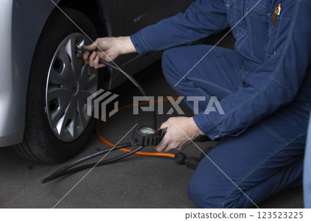 A man maintaining a car 123523225