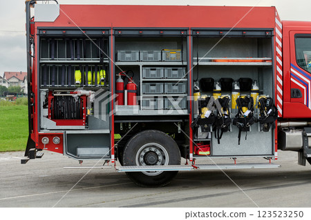 In this captivating scene, a state-of-the-art firetruck, equipped with advanced rescue technology, stands ready with its skilled firefighting team, prepared to intervene and respond rapidly to In this captivating scene, a state-of-the-art firetruck, equipped with advanced rescue technology, stands ready with its skilled firefighting team, prepared to intervene and respond rapidly to 123523250