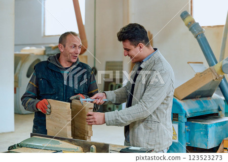 Production Manager Demonstrating Woodcraft Techniques to Employee for Decorative and Residential Items 123523273
