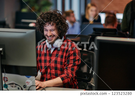 Focused Programmer With Afro Hairstyle in Plaid Shirt Working on Computer in Office Environment 123523280