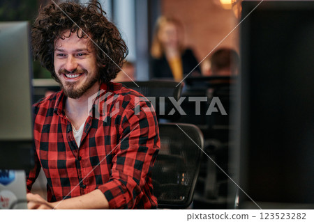 Focused Programmer With Afro Hairstyle in Plaid Shirt Working on Computer in Office Environment 123523282