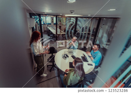 A group of young business entrepreneurs engages in a focused meeting, discussing various business strategies and collaboratively solving challenging problems, showcasing ambition, creativity, and 123523286