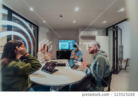 A diverse group of businessmen collaborates and tests a new virtual reality technology, wearing virtual glasses, showcasing innovation and creativity in their futuristic workspace 123523288
