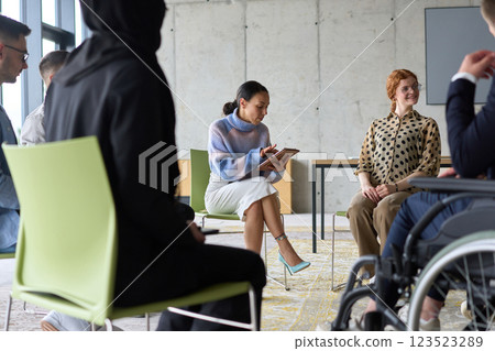 Corporate business team meeting with a manager or coach. Group of happy diverse, multiracial people sitting in a circle  123523289