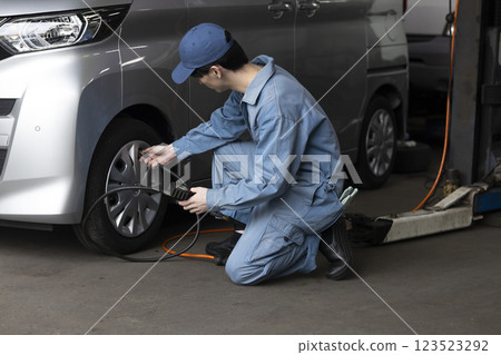 A man maintaining a car A man maintaining a car 123523292