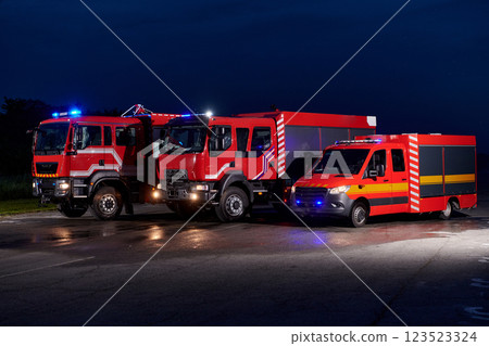 A pair of highly modern and quality fire trucks illuminate the night with their rotating lights, symbolizing the cutting-edge technology and preparedness of the firefighting fleet, ready to respond to A pair of highly modern and quality fire trucks illuminate the night with their rotating lights, symbolizing the cutting-edge technology and preparedness of the firefighting fleet, ready to respond to 123523324