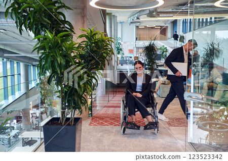In a modern office, a young businesswoman in a wheelchair is surrounded by her supportive colleagues, embodying the spirit of inclusivity and diversity in the workplace 123523342