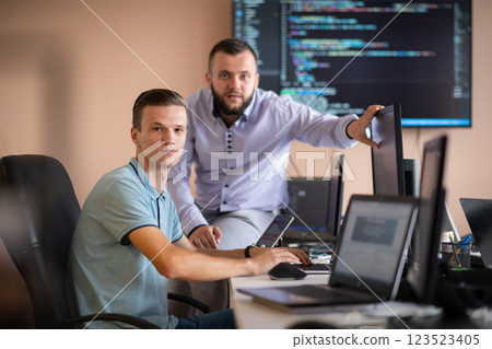 Programmers engrossed in deep collaboration, diligently working together to solve complex problems Programmers engrossed in deep collaboration, diligently working together to solve complex problems 123523405