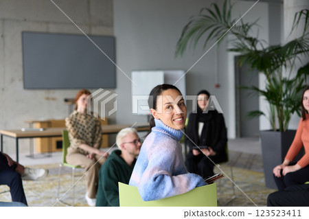 A diverse group of business professionals sits attentively in a modern office, actively participating in a training session led by an instructor, focusing on the latest technological advancements in A diverse group of business professionals sits attentively in a modern office, actively participating in a training session led by an instructor, focusing on the latest technological advancements in 123523411