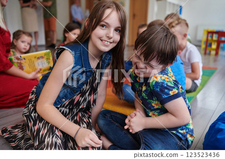 A girl and a boy with Down's syndrome in each other's arms spend time together in a preschool institution 123523436