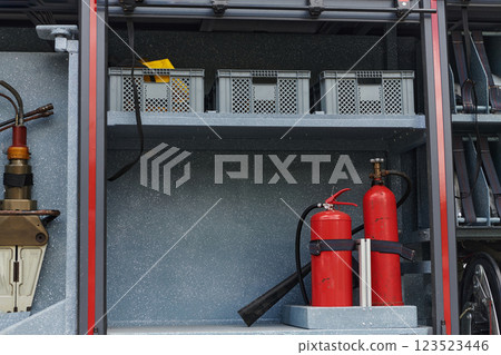 Close-up of essential firefighting equipment on a modern firetruck, showcasing tools and gear ready for emergency response to hazardous fire situations Close-up of essential firefighting equipment on a modern firetruck, showcasing tools and gear ready for emergency response to hazardous fire situations 123523446