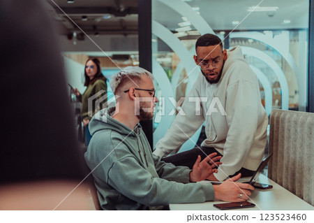 Young group of business people brainstorming together in a startup space, discussing business projects, investments, and solving challenges. 123523460