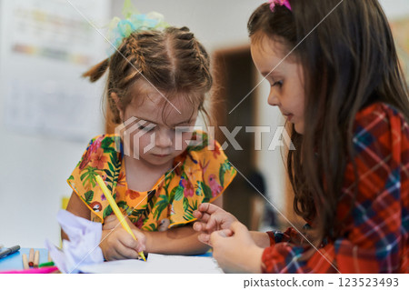 Creative kids sitting in a preschool institution, draw and have fun while they get an education 123523493