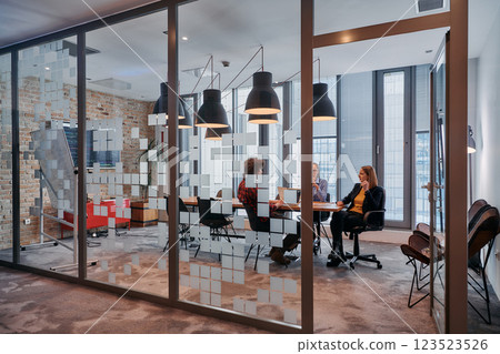 In the dynamic hustle and bustle of a business environment, a group of young business professionals walk down the corridor next to their office, while their colleagues collaborate inside, symbolizing In the dynamic hustle and bustle of a business environment, a group of young business professionals walk down the corridor next to their office, while their colleagues collaborate inside, symbolizing 123523526