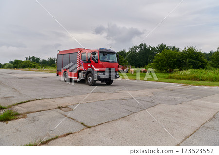 In this captivating scene, a state-of-the-art firetruck, equipped with advanced rescue technology, stands ready with its skilled firefighting team, prepared to intervene and respond rapidly to 123523552
