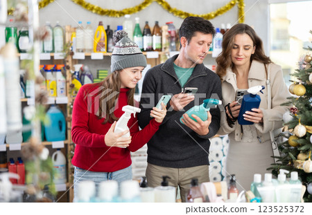 Couple man and woman with daughter scanning qr code for cleaning spray 123525372