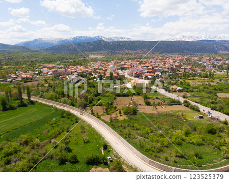 Drone view of Yesildag village in green valley surrounded by mountains, Turkey 123525379
