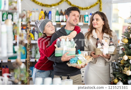 Family shopping for Christmas presents together in supermarket Family shopping for Christmas presents together in supermarket 123525381