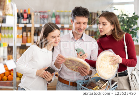 Family of buyers scans QR code on various of pizza packaging 123525450