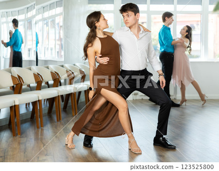 Latin American guy and girl performing kizomba in dance studio 123525800