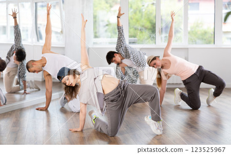 Young girl practicing breakdance floor-works in training hall Young girl practicing breakdance floor-works in training hall 123525967