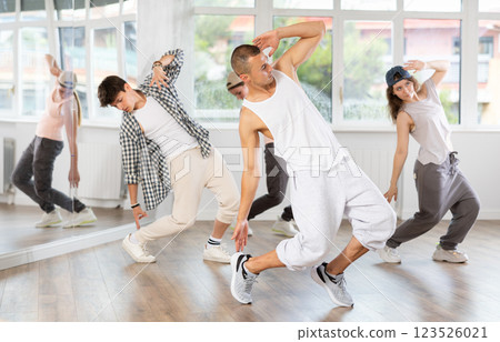Young guy practicing breakdance in training hall Young guy practicing breakdance in training hall 123526021