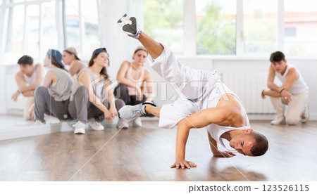 Dance teacher shows how to dance breaking in dance studio 123526115