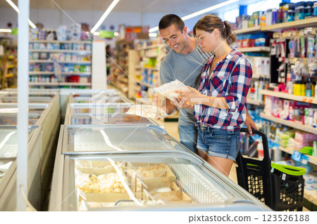 Woman and man choosing frozen food in supermarket 123526188