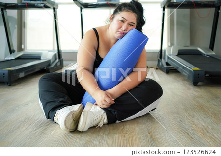Healthy fat women so tired after exercise. Asian woman fitness exercise for lose weigh Healthy fat women so tired after exercise. Asian woman fitness exercise for lose weigh 123526624