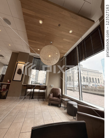 cozy cafe interior featuring stylish furniture, subdued lighting, and a warm, welcoming ambiance ideal for relaxation, conversation, and enjoying a cup of coffee or tea. cozy cafe interior featuring stylish furniture, subdued lighting, and a warm, welcoming ambiance ideal for relaxation, conversation, and enjoying a cup of coffee or tea. 123527163