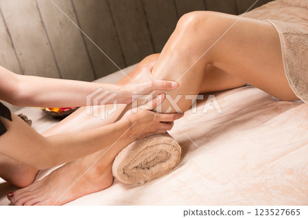 A young Asian woman is getting a leg oil massage. 123527665