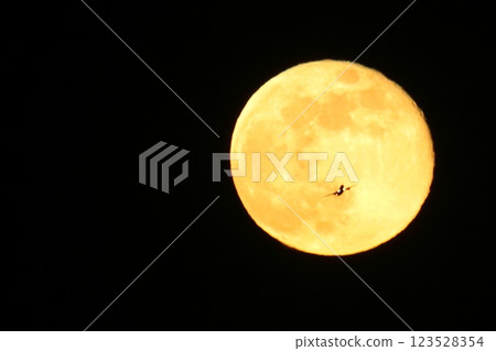 Airplane heading towards the full moon 123528354