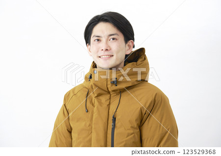 Man wearing down jacket, portrait, white background 123529368