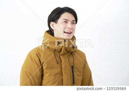 Man wearing down jacket, portrait, white background 123529369