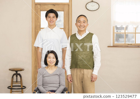 Care image: wife in wheelchair, husband and caregiver Care image: wife in wheelchair, husband and caregiver 123529477