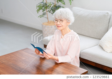 Senior woman checking her pension book Senior woman checking her pension book 123529661