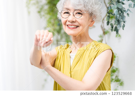 Senior woman wearing a yellow dress Senior woman wearing a yellow dress 123529668