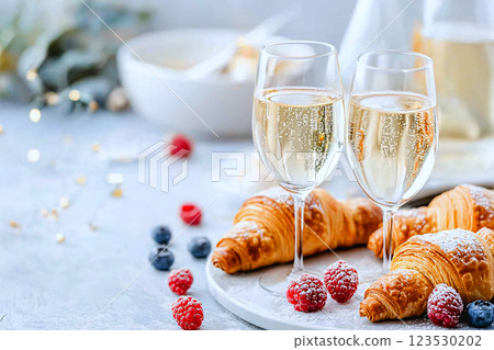 A luxurious morning spread with croissants,berries and champagne, perfect for an indulgent breakfast 123530202