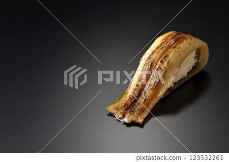 Grilled conger eel sushi photographed against a black background Grilled conger eel sushi photographed against a black background 123532261